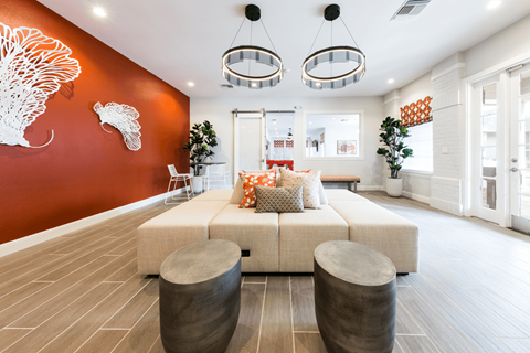 a living room with an orange wall and a couch